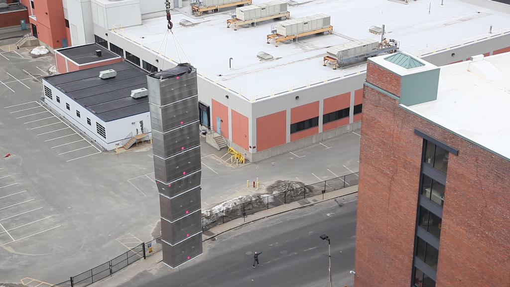 loading ductwork with crane onto building